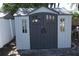 Exterior shot of backyard shed with double doors, windows, and contrasting trim at 1509 Lemon St, Clearwater, FL 33756