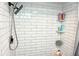 Shower with white subway tile, a rainfall shower head, and built-in corner shelves at 1509 Lemon St, Clearwater, FL 33756