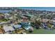 An aerial view showcases the home's pool, backyard, boat dock, and waterfront location at 15904 Redington Dr, Redington Beach, FL 33708