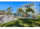 A spacious backyard with a pool, outdoor kitchen, and stairs leading to a balcony, creating a relaxing retreat at 15904 Redington Dr, Redington Beach, FL 33708