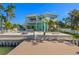 Gorgeous waterfront backyard with a luxurious pool, spa, dock, and outdoor entertaining space at 15904 Redington Dr, Redington Beach, FL 33708