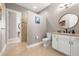 Neutral-toned bathroom with an updated vanity, commode, and walk-in shower at 15904 Redington Dr, Redington Beach, FL 33708