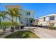Charming coastal home with a two-car garage, extra parking, and lush tropical landscaping at 15904 Redington Dr, Redington Beach, FL 33708
