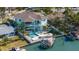 Stunning waterfront home with pool, boat dock, and lush tropical landscaping at 15904 Redington Dr, Redington Beach, FL 33708