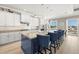 Modern kitchen featuring an island with seating and stainless steel appliances at 15904 Redington Dr, Redington Beach, FL 33708