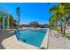 A private pool is surrounded by travertine tile, landscaping, and provides a great space for outdoor relaxation at 15904 Redington Dr, Redington Beach, FL 33708
