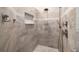 Tiled walk-in shower with a rain shower head and built-in niche at 15904 Redington Dr, Redington Beach, FL 33708