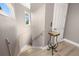 Stairway with views of a bright window and a small table with decorative trim at 15904 Redington Dr, Redington Beach, FL 33708