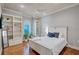 Cozy bedroom with hardwood floors, white furniture, built-in shelving, and natural light at 16205 Sierra De Avila, Tampa, FL 33613