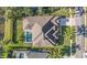 This home features an aerial view of its backyard pool, screened in for year-round enjoyment at 18823 Wimbledon Cir, Lutz, FL 33558
