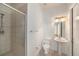 Bright bathroom featuring a glass door shower, pedestal sink, and tiled floors at 18823 Wimbledon Cir, Lutz, FL 33558