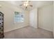 Bedroom with carpet, a window, a closet door, and neutral paint at 18823 Wimbledon Cir, Lutz, FL 33558