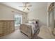 Bedroom with neutral walls, carpet, and a large window at 18823 Wimbledon Cir, Lutz, FL 33558