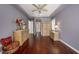 Bedroom with hardwood floors, a ceiling fan, and neutral-colored furniture at 18823 Wimbledon Cir, Lutz, FL 33558
