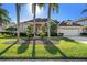 Charming home with a well-manicured lawn and meticulous landscaping at 18823 Wimbledon Cir, Lutz, FL 33558