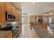 Open kitchen with stainless steel appliances, granite countertops, and a breakfast bar at 18823 Wimbledon Cir, Lutz, FL 33558