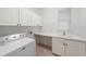 Laundry room featuring a white washing machine, sink, countertop, and white cabinets at 18823 Wimbledon Cir, Lutz, FL 33558