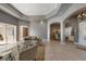 Spacious living room with tile flooring, arched doorways, and a view into the formal dining area at 18823 Wimbledon Cir, Lutz, FL 33558