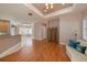 Combined living area with hardwood flooring, flowing to kitchen and breakfast nook at 18823 Wimbledon Cir, Lutz, FL 33558
