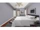 Spacious main bedroom with tray ceiling, modern decor, and neutral colors at 18823 Wimbledon Cir, Lutz, FL 33558