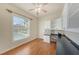 Home office with a view of the pool, built-in desk, cabinets, drawers, and hardwood floors at 18823 Wimbledon Cir, Lutz, FL 33558