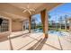 Spacious screened patio with tile flooring, ceiling fans, and view of the pool at 18823 Wimbledon Cir, Lutz, FL 33558