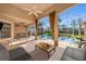 Outdoor patio with ceiling fan, views of pool and outdoor dining at 18823 Wimbledon Cir, Lutz, FL 33558