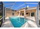 The pool is surrounded by a screened enclosure, offering a private and enjoyable outdoor space at 18823 Wimbledon Cir, Lutz, FL 33558