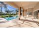 Screened-in lanai with a beautiful pool and view of the well-maintained landscaping at 18823 Wimbledon Cir, Lutz, FL 33558