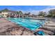 Long, blue pool with a diving board and lounge chairs, ideal for recreation at 18823 Wimbledon Cir, Lutz, FL 33558