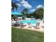 Community swimming pool with lounge chairs, umbrellas and clear blue water at 2332 Dekan Ln, Land O Lakes, FL 34639