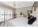 Main bedroom with sliding glass doors, dresser, hardwood floors, and neutral paint at 2332 Dekan Ln, Land O Lakes, FL 34639