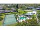 An expansive aerial view showcases the community pool, clubhouse, and tennis courts at 2345 Bentley Dr, Palm Harbor, FL 34684