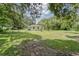 Expansive, tree-lined backyard offering privacy and space at 2708 De Montmollin Rd, Plant City, FL 33565