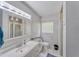 Clean bathroom featuring white cabinets, a large vanity, and a tiled walk-in shower at 2708 De Montmollin Rd, Plant City, FL 33565