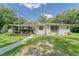 Charming single-story home with a covered porch, lush lawn, and decorative accents creating a welcoming curb appeal at 2708 De Montmollin Rd, Plant City, FL 33565