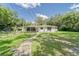 Charming single-story home with a covered porch, lush lawn, and decorative accents creating a welcoming curb appeal at 2708 De Montmollin Rd, Plant City, FL 33565