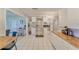 Open kitchen boasts stainless steel refrigerator, white cabinets, and butcher block countertops at 2708 De Montmollin Rd, Plant City, FL 33565