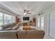 Bright living room featuring neutral decor, comfortable seating, tile flooring, and large windows that flood the space with light at 2708 De Montmollin Rd, Plant City, FL 33565