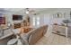 Inviting living room showcasing tile floors, modern furnishings, decorative elements, and access to the outdoors at 2708 De Montmollin Rd, Plant City, FL 33565