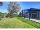 Spacious backyard featuring a screened-in pool, shed, lush green lawn, and mature trees at 3115 Bent Creek Dr, Valrico, FL 33596