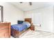 Cozy bedroom featuring a twin bed, wood furnishings, neutral walls, and natural light from the window at 3115 Bent Creek Dr, Valrico, FL 33596