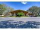 Elegant clubhouse entrance with circular driveway, manicured flower beds, stone pillars, and a covered porte cochere at 3115 Bent Creek Dr, Valrico, FL 33596
