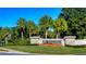 Welcoming entrance to River Hills Golf and Country Club community with lush landscaping and a clear blue sky at 3115 Bent Creek Dr, Valrico, FL 33596