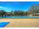 Large community swimming pool with marked lanes and a lifeguard stand on a sunny day with blue sky at 3115 Bent Creek Dr, Valrico, FL 33596
