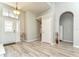 Spacious entryway with light wood floors, neutral walls, and an arched doorway at 3115 Bent Creek Dr, Valrico, FL 33596