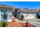 Single-story home featuring a well-maintained lawn, manicured landscaping, and a two-car garage at 3115 Bent Creek Dr, Valrico, FL 33596