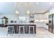 Modern kitchen featuring white cabinetry, stainless steel appliances, and a large island at 3115 Bent Creek Dr, Valrico, FL 33596