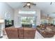 Cozy living room with comfortable seating and a view of the screened-in pool area at 3115 Bent Creek Dr, Valrico, FL 33596
