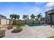 Beautiful backyard featuring a pool, brick fire pit, and patio with lush tropical landscaping at 3654 Beneraid St, Land O Lakes, FL 34638